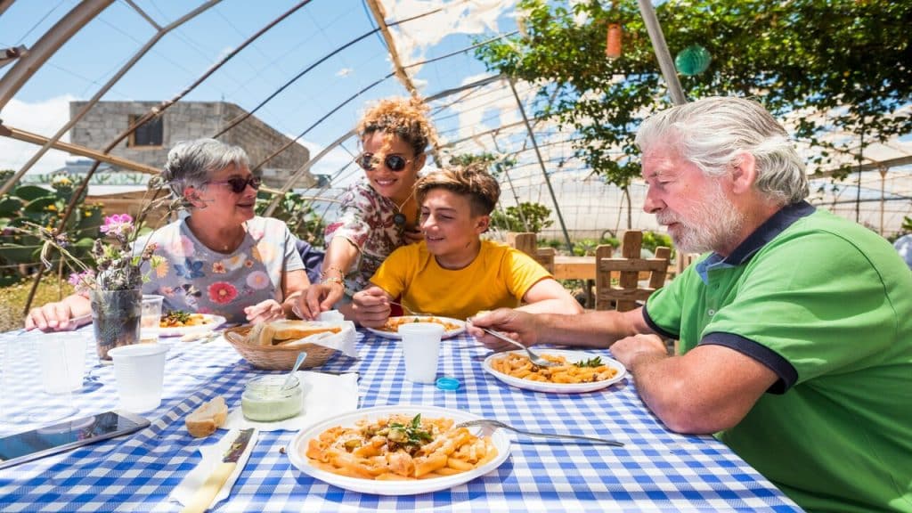 An older couple having lunch with their younger family members