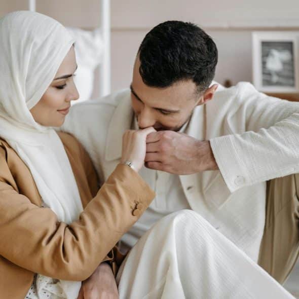 A man kissing a woman’s hand as a sign of respect