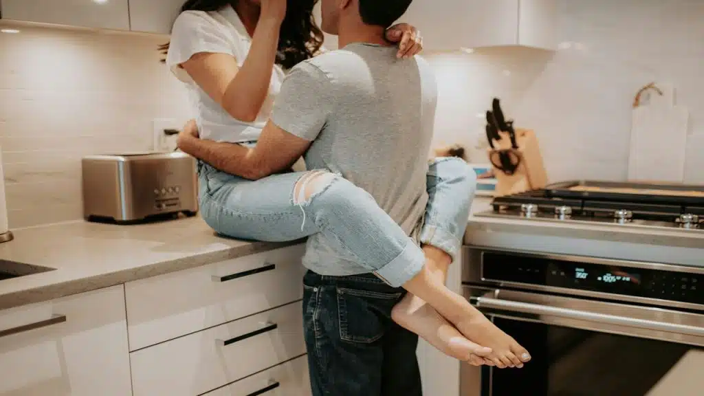A couple hugging in the kitchen