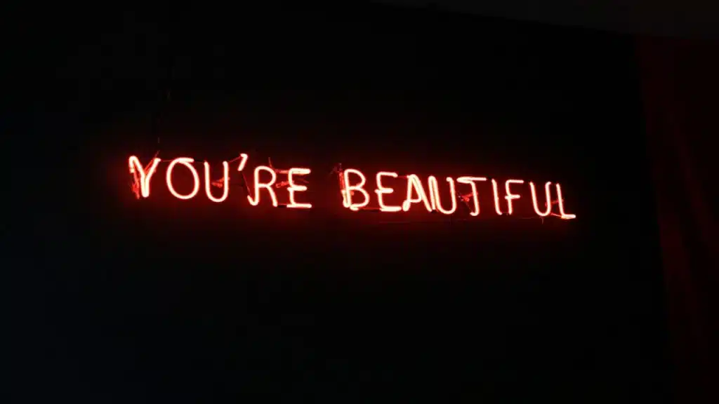 Neon lights spelling out “you’re beautiful”