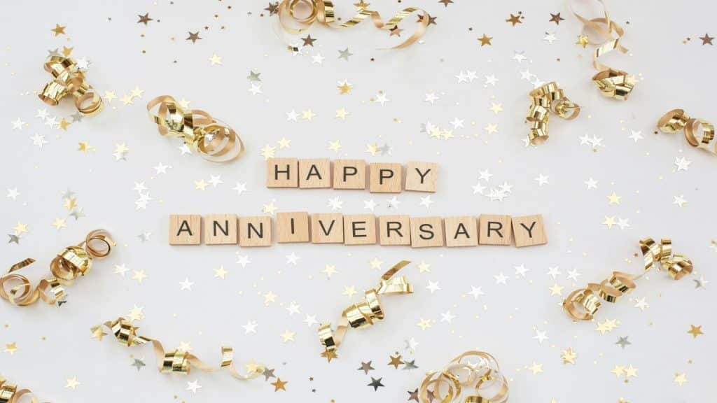 Scrabble blocks spelling out “happy anniversary”