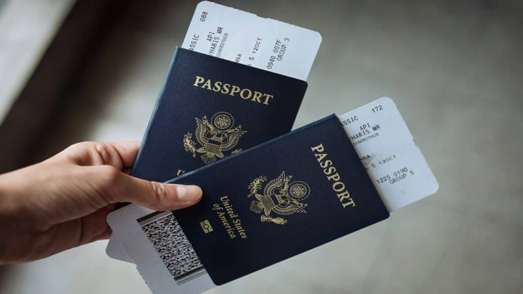 A person holding two passports with boarding passes