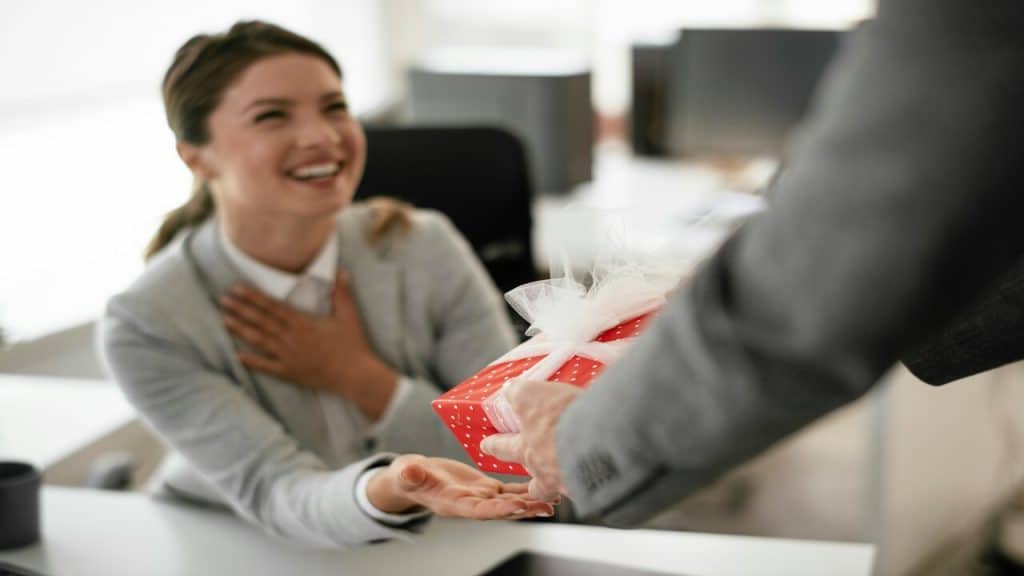 A woman receiving a gift in the office