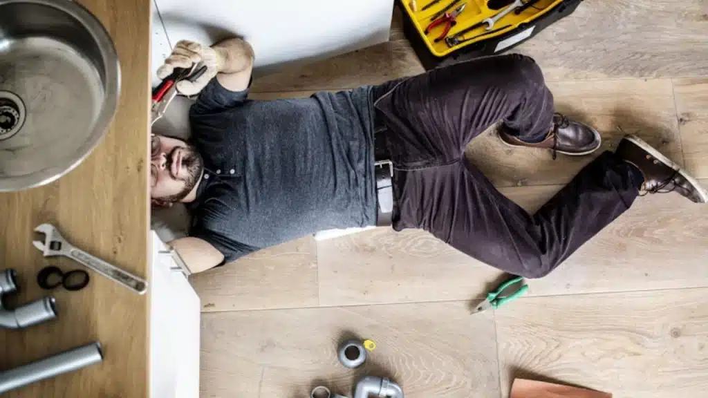 Man repairing a kitchen sink