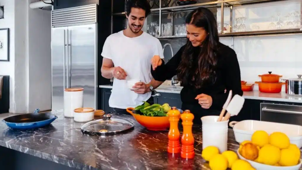 Couple cooking a healthy meal together in a modern kitchen