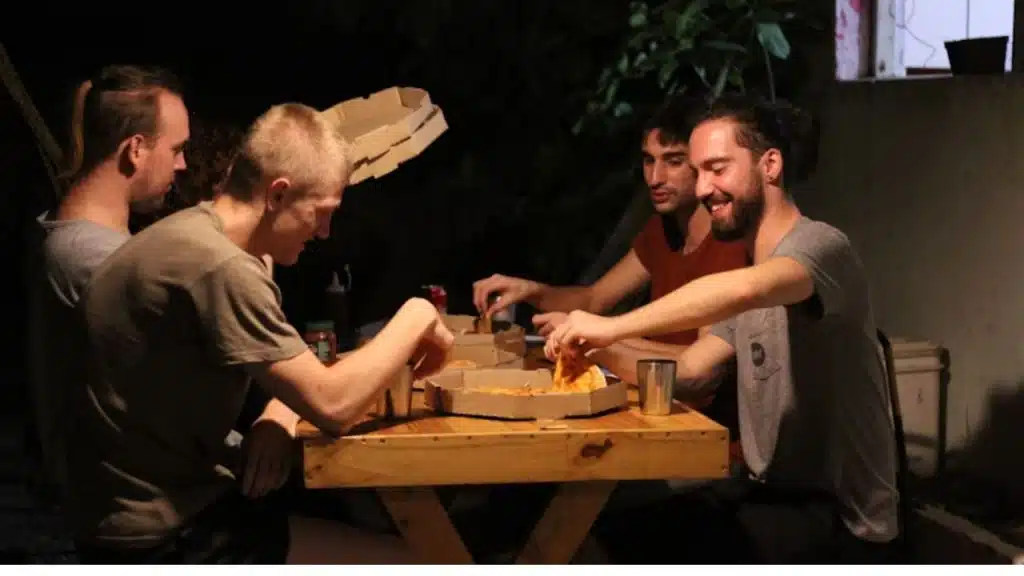 Group of male friends smiling at a dinner table