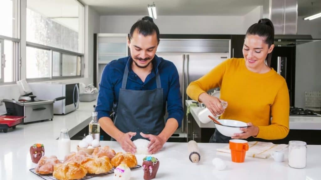 Couple smiling together while cooking in the kitchen
