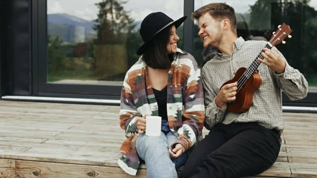 Couple sitting together but enjoying separate hobbies