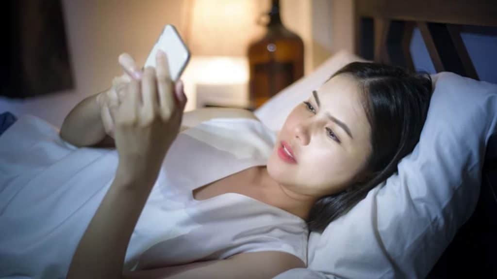 Woman texts secretly in bed