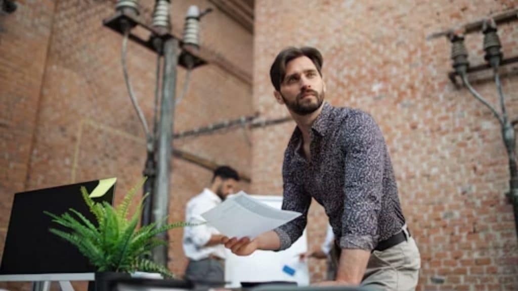 A man looking frustrated after checking a vacation calendar with partner