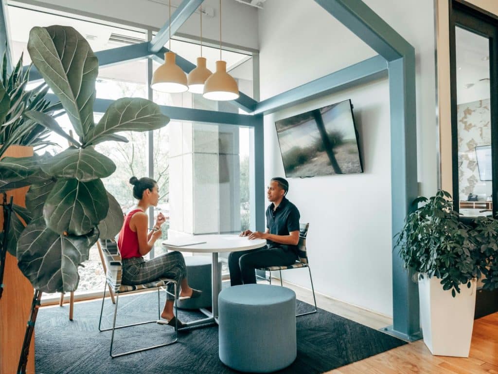 A man and woman talking at the dining area