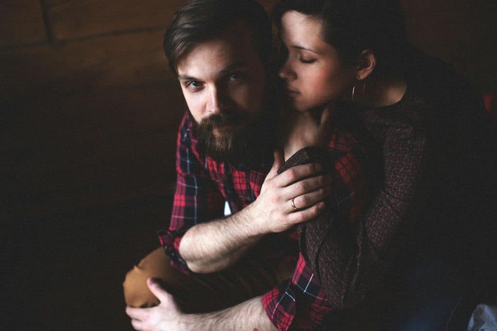 A woman hugging a man