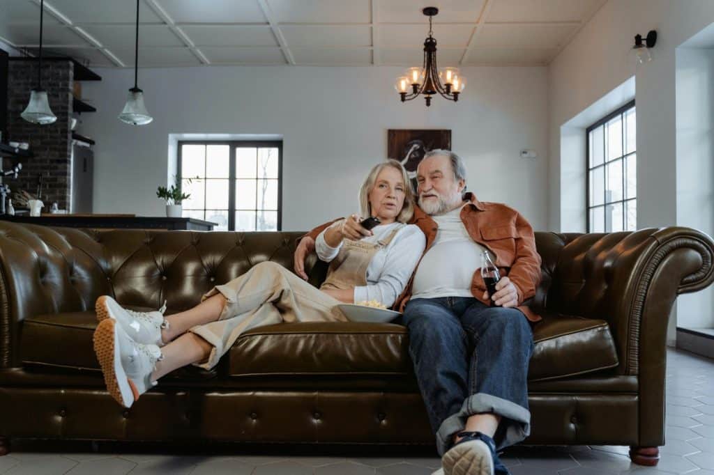 A married couple sitting at the couch 