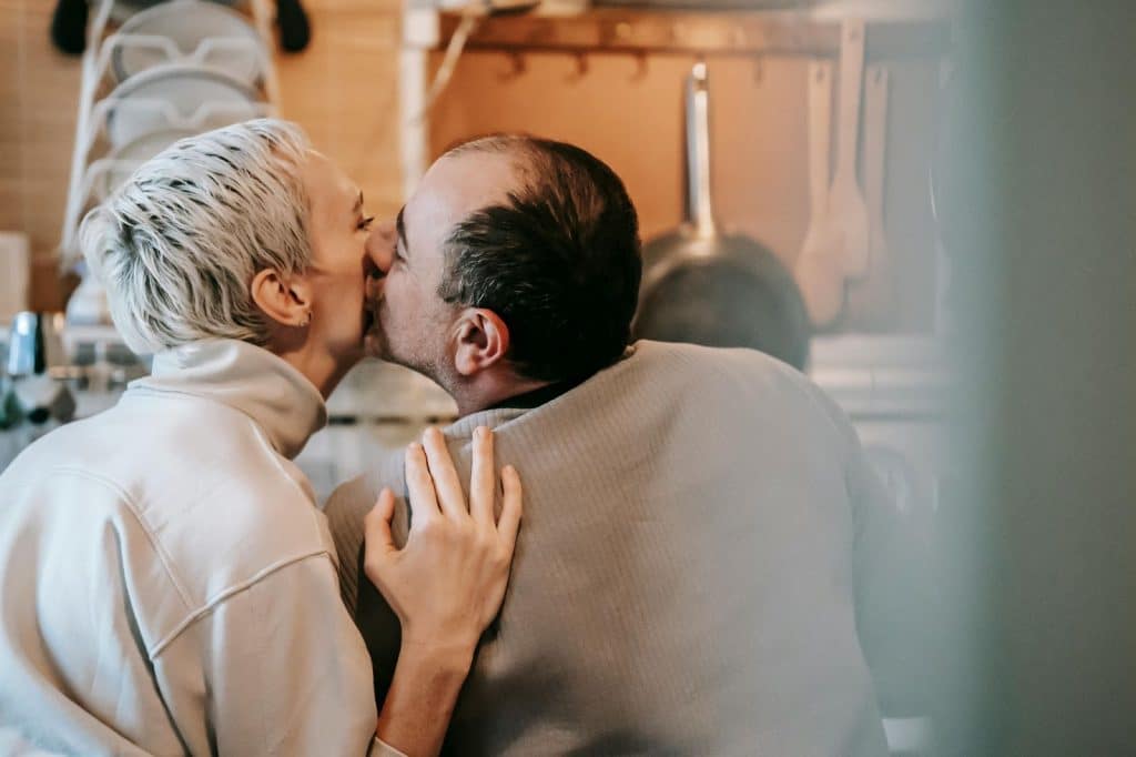 A man kissing a woman’s cheek