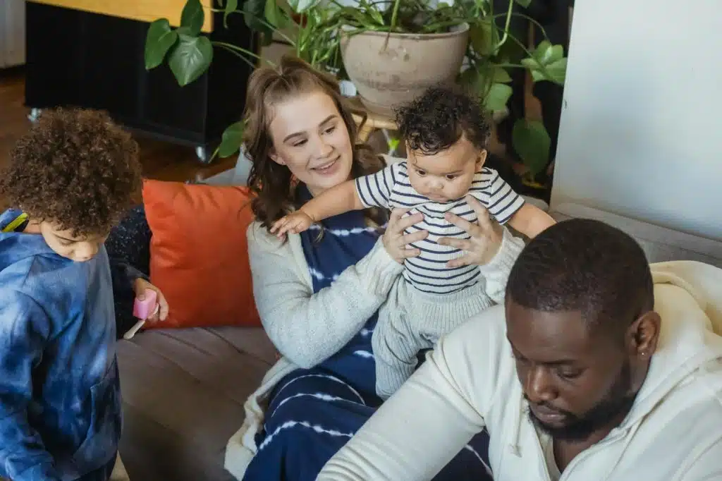 A man and woman taking care of their children
