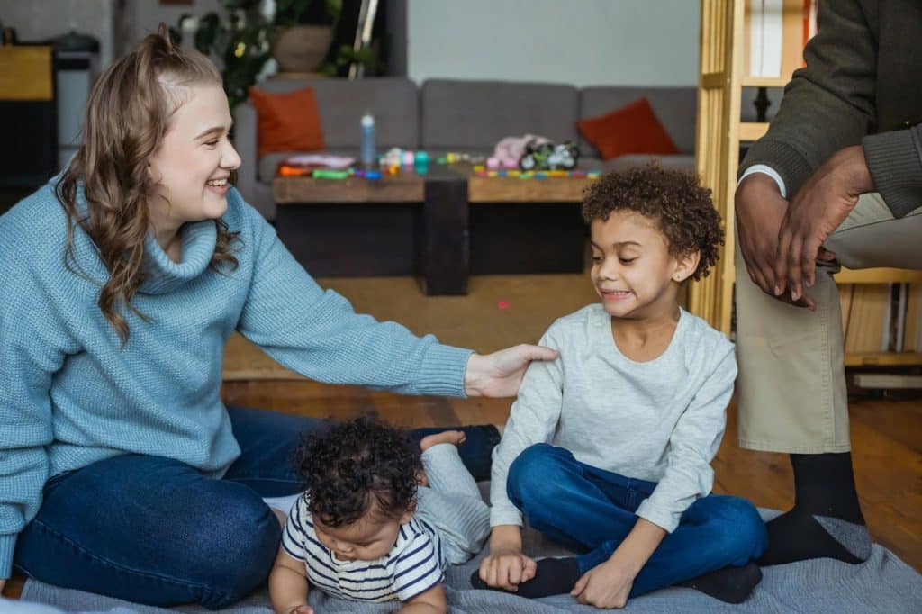 A woman playing with the children