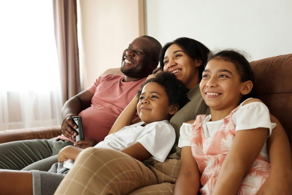 A couple and their children watching together