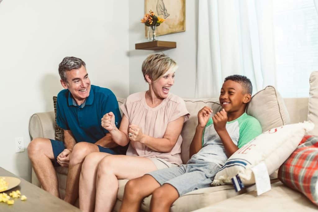 A man and woman having a good laugh with their child