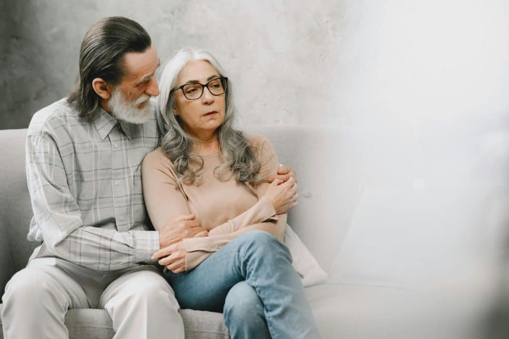 A man comforting a woman