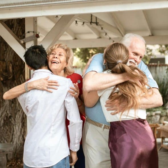 Couple hugging their son and daughter