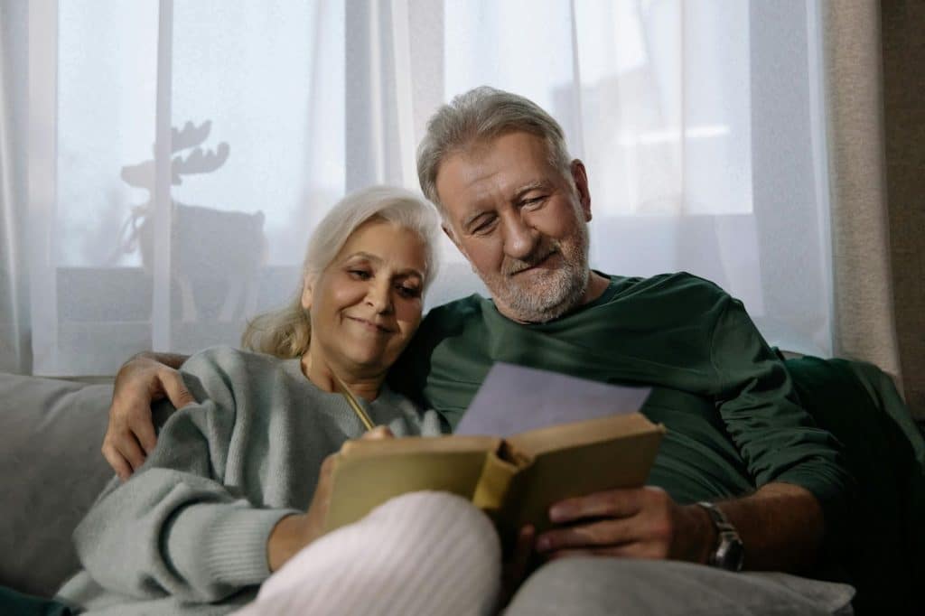 A man and woman writing in their journal