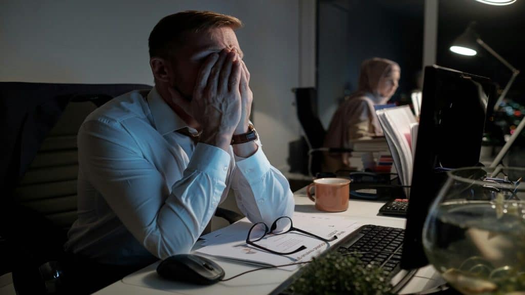 A man looking stressed at work
