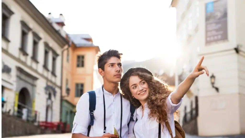 Wife looking excited on a trip while husband shows no interest
