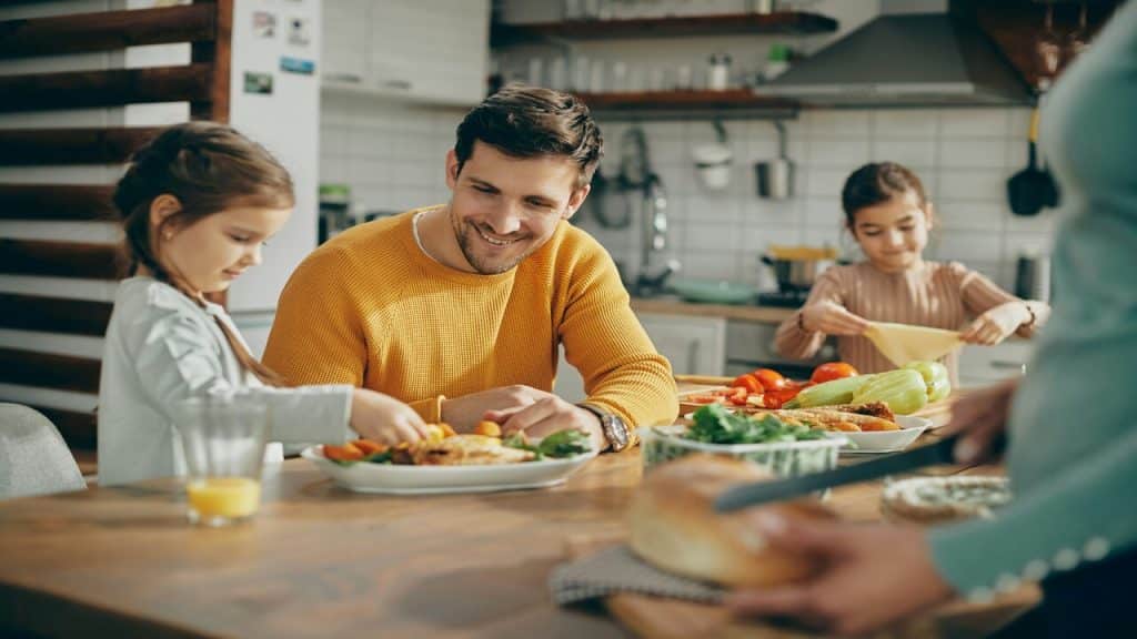 A young family cooking together