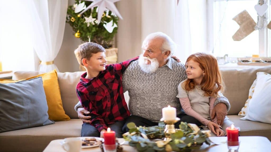 A grandpa celebrating Christmas with grandkids.