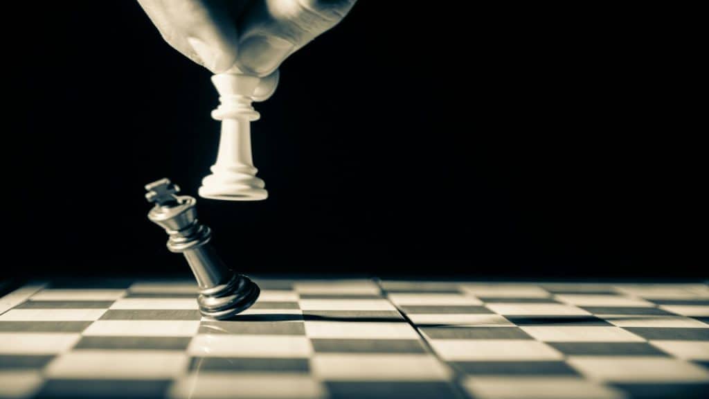 A person being beaten in chess.
