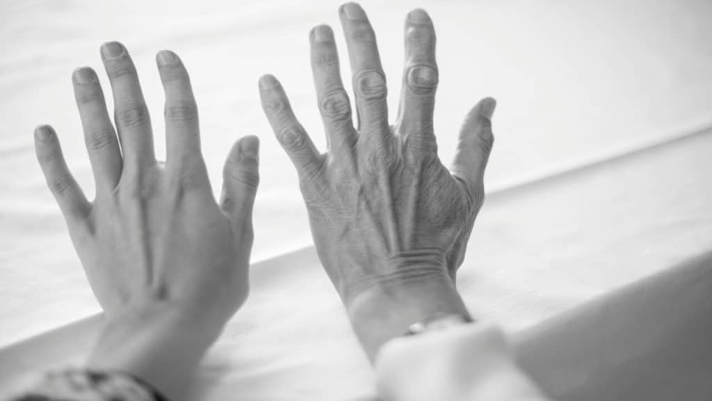 A photo of two hands of different ages