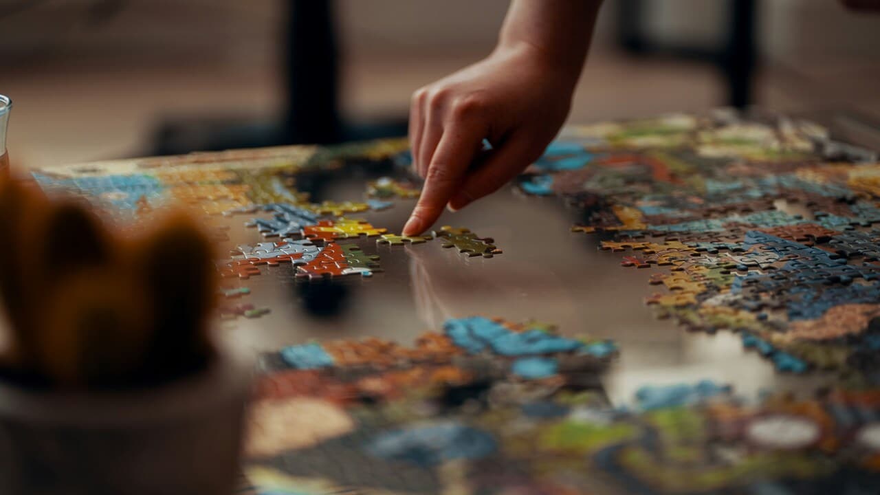 A person doing a jigsaw puzzle.