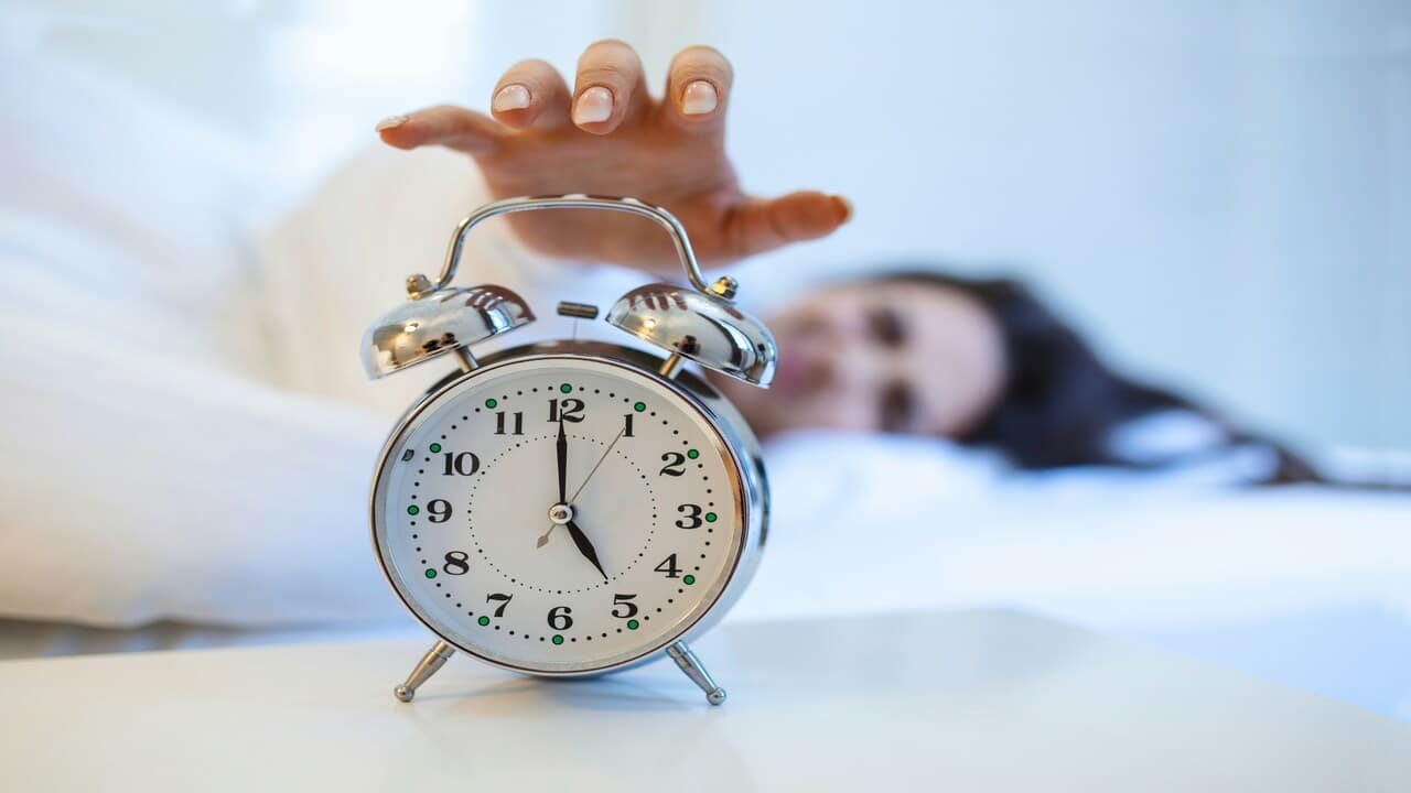 A woman waking up too early