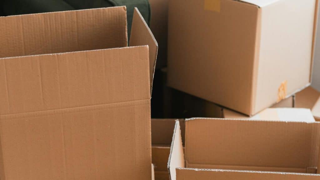 A stack of open and closed cardboard boxes used for moving or storage.