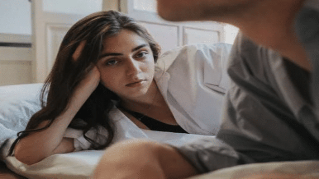 A woman looking sadly at her husband