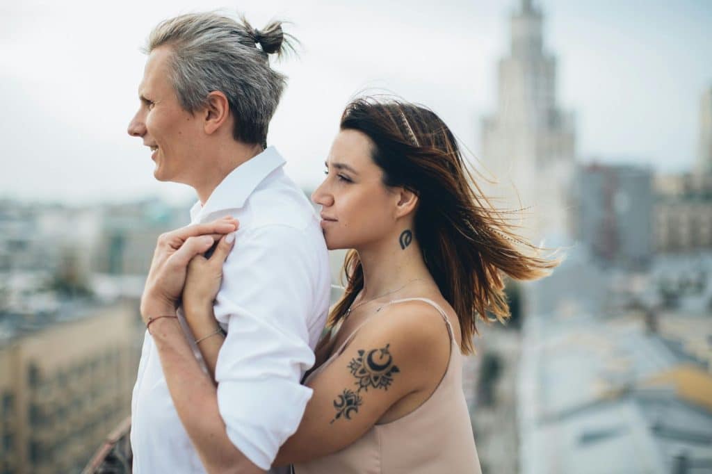 A woman hugging a man