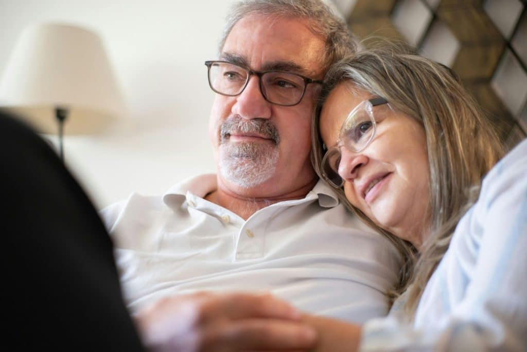 A man and woman leaning to each other