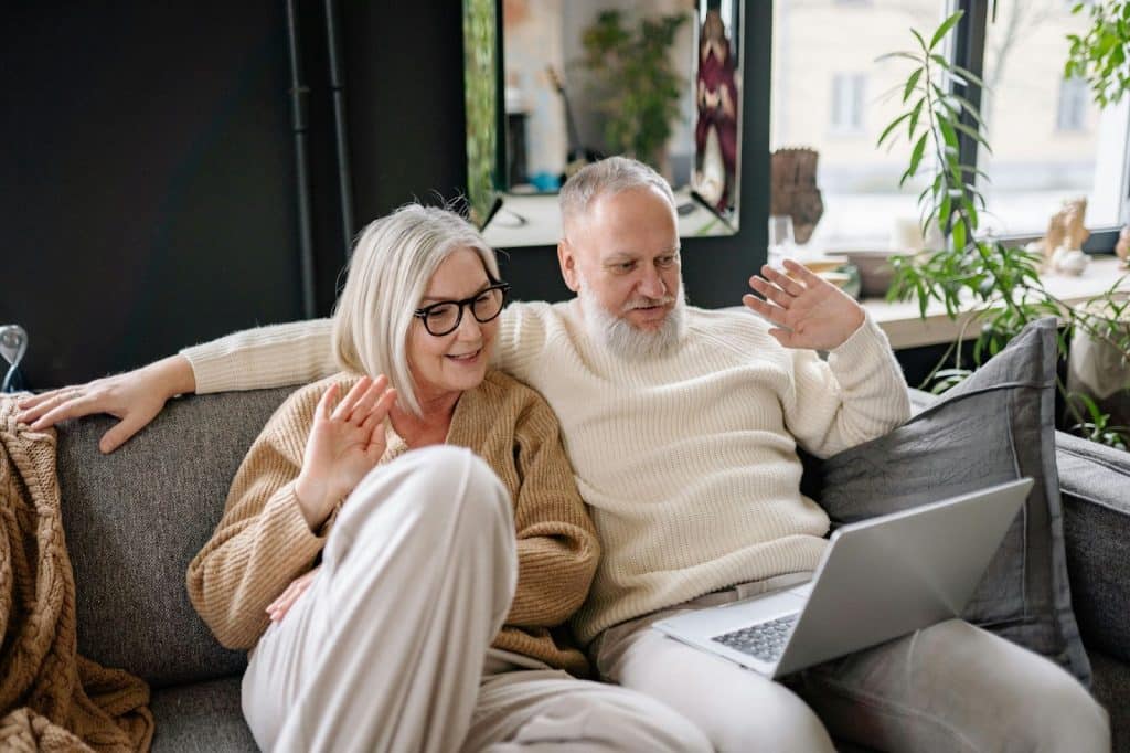 A man and woman sitting at the sofa
