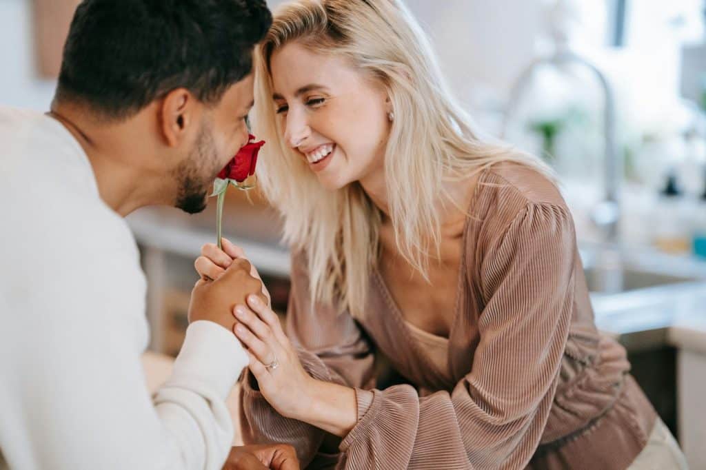 A man giving a woman a flower