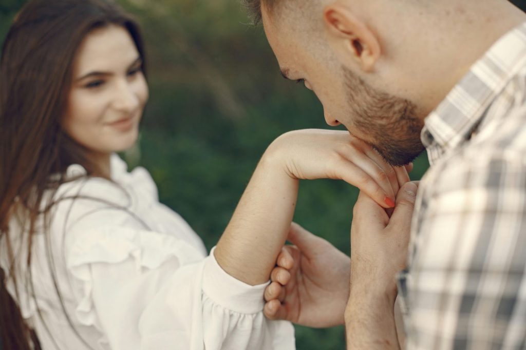 A man kissing a woman’s hand