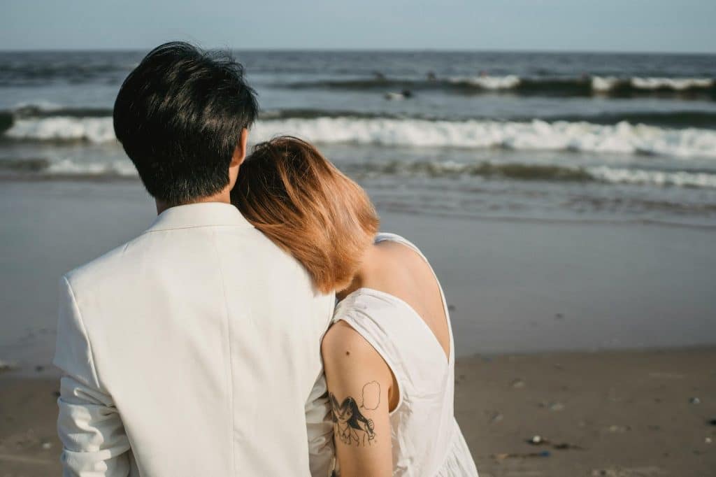 A man and woman looking at the beach