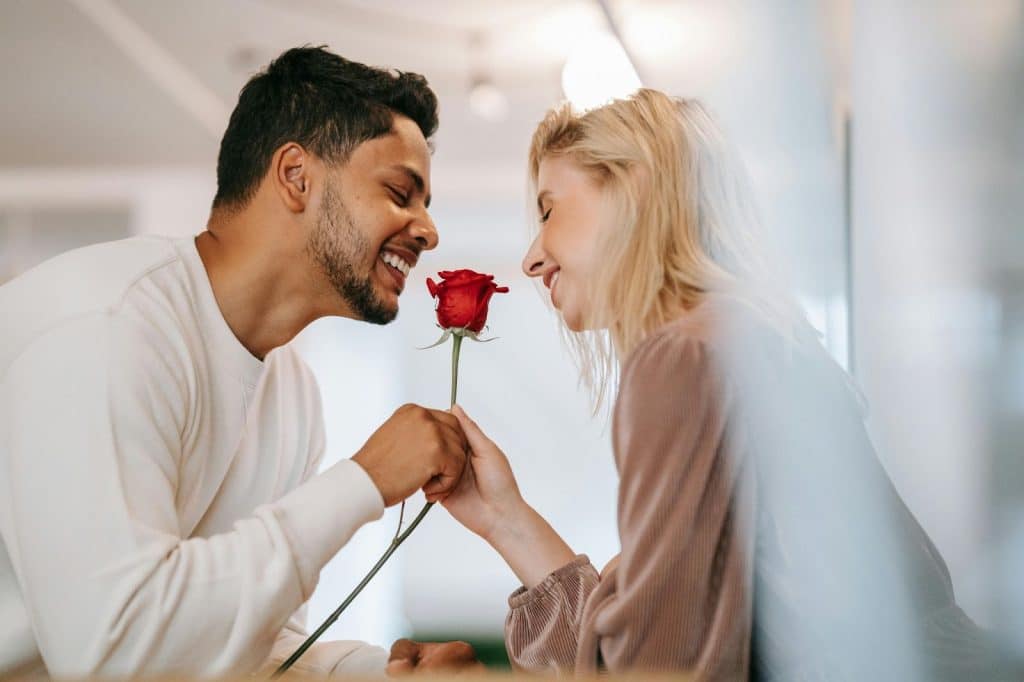 A man giving a woman a flower