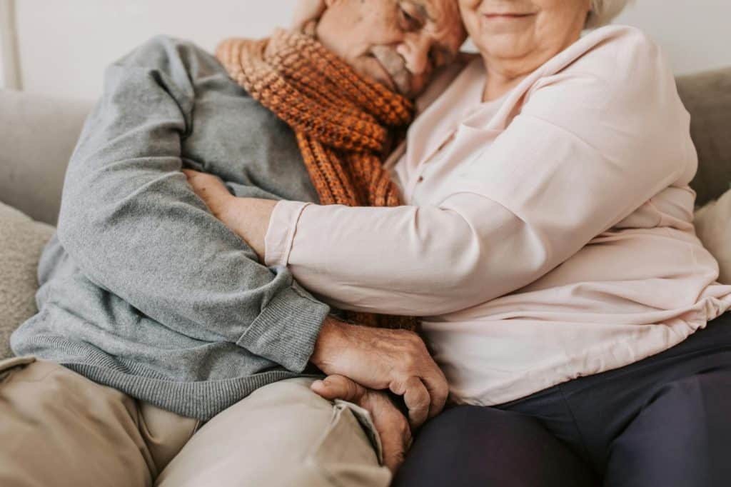 A man and woman embracing each other