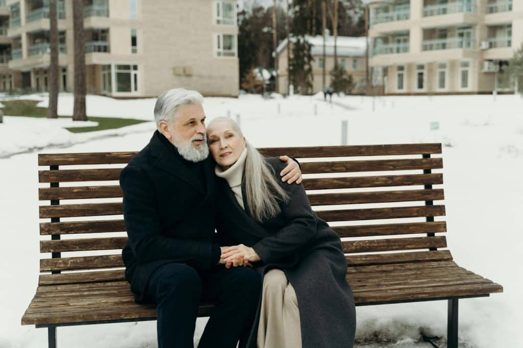 A man and woman sitting at the bench