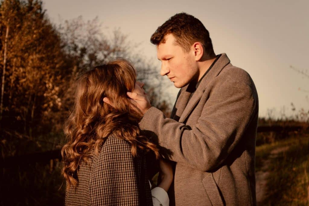 A man caressing a woman’s face