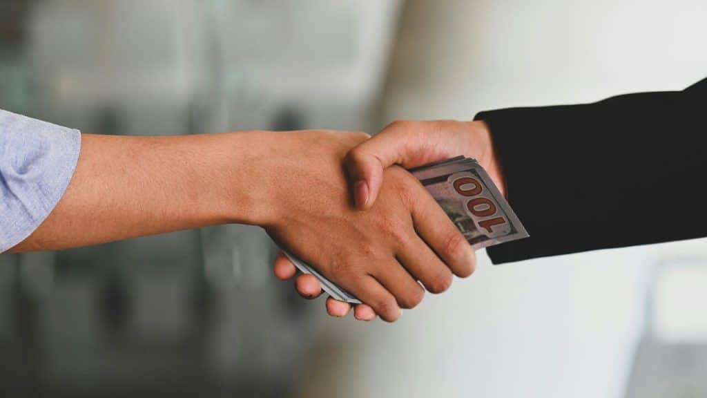 A man receiving a bribe
