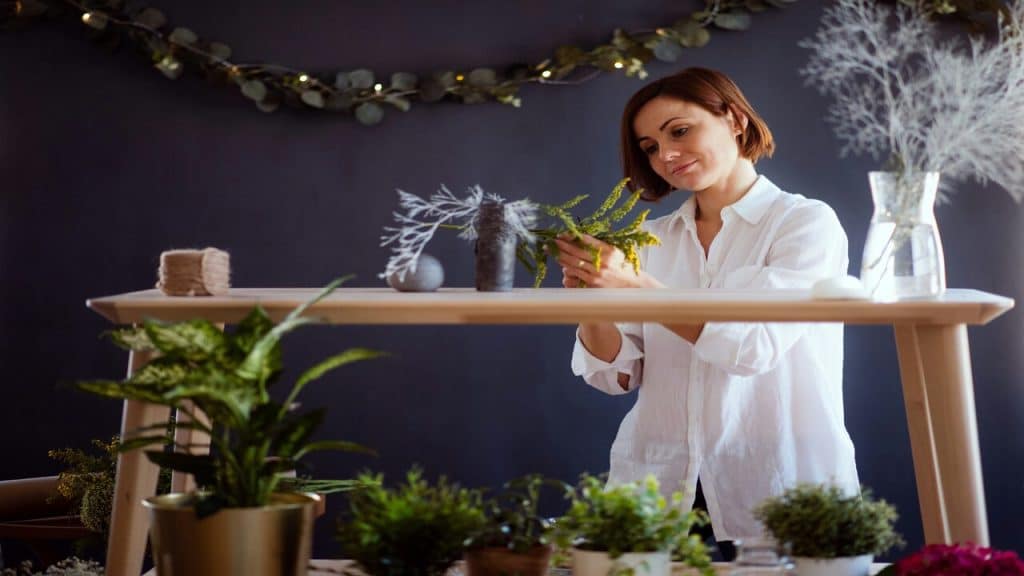 A mature woman arranging flowers