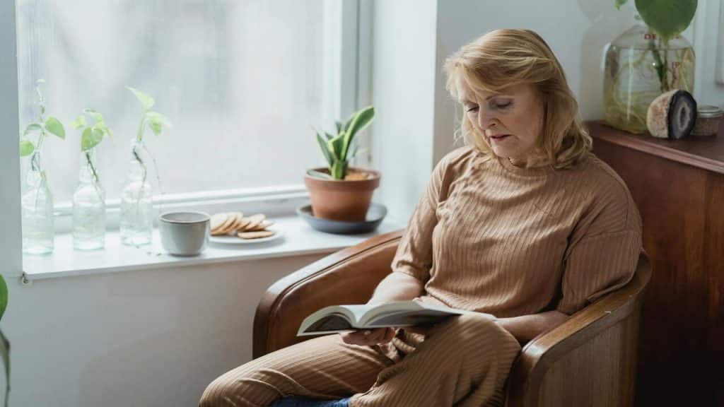 A woman reading a book at home