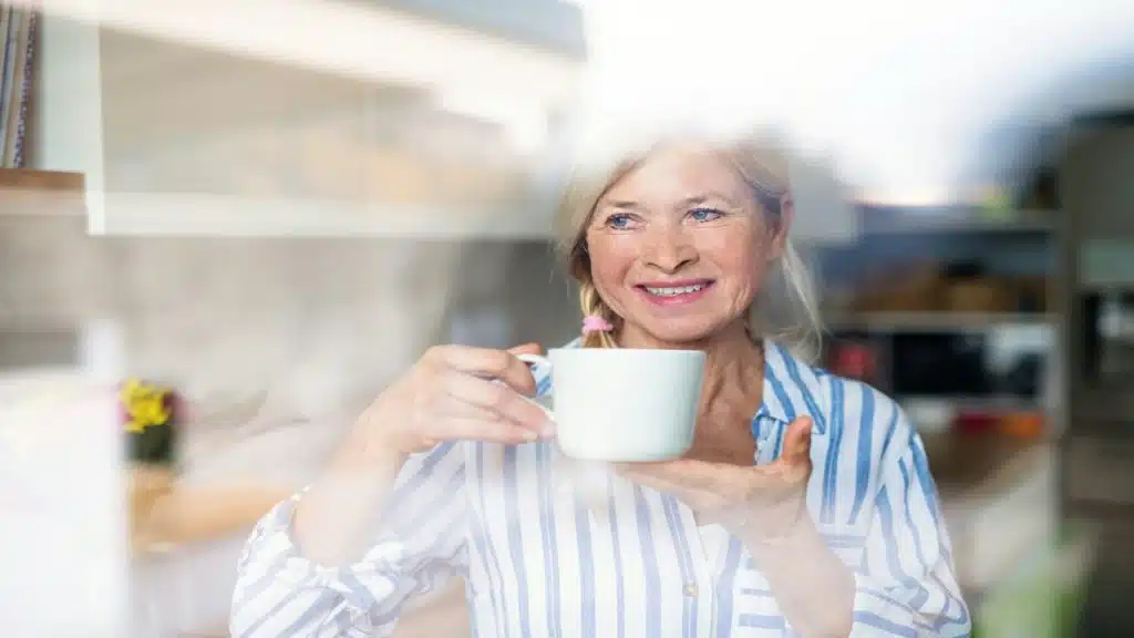 A beautiful mature woman enjoying coffee at home