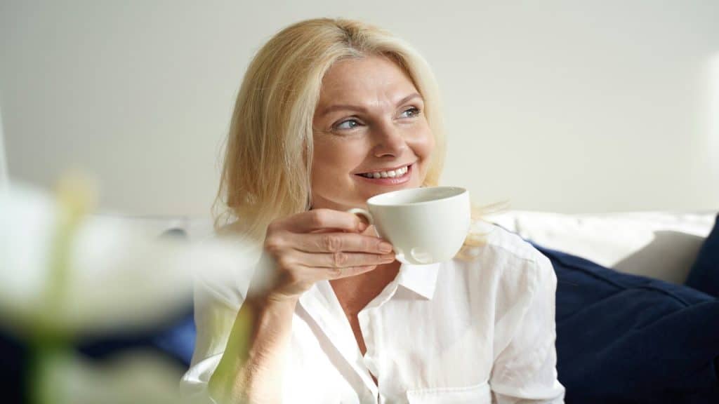 A woman enjoying her coffee at home 
